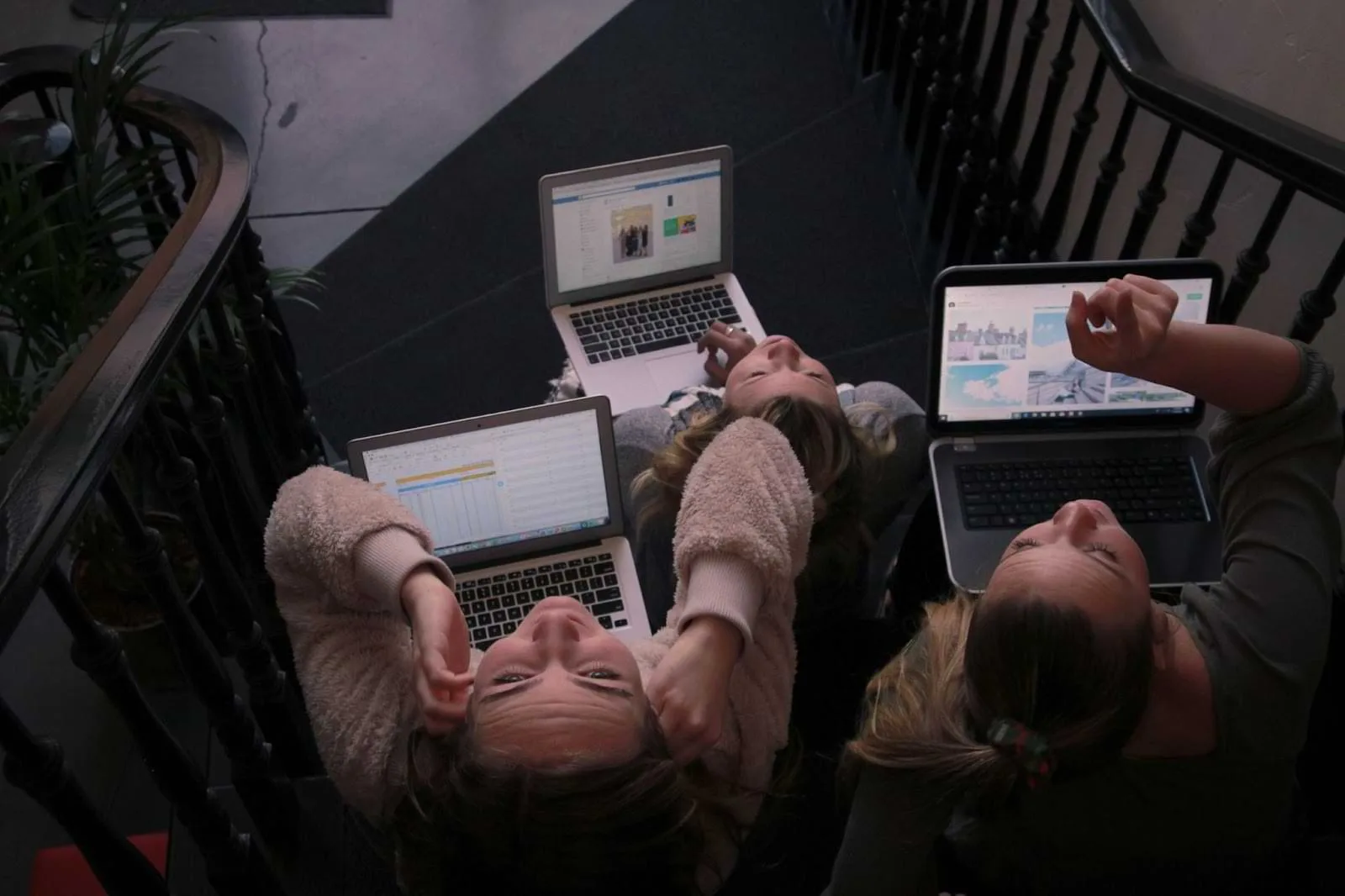 Two people in front of their laptops
