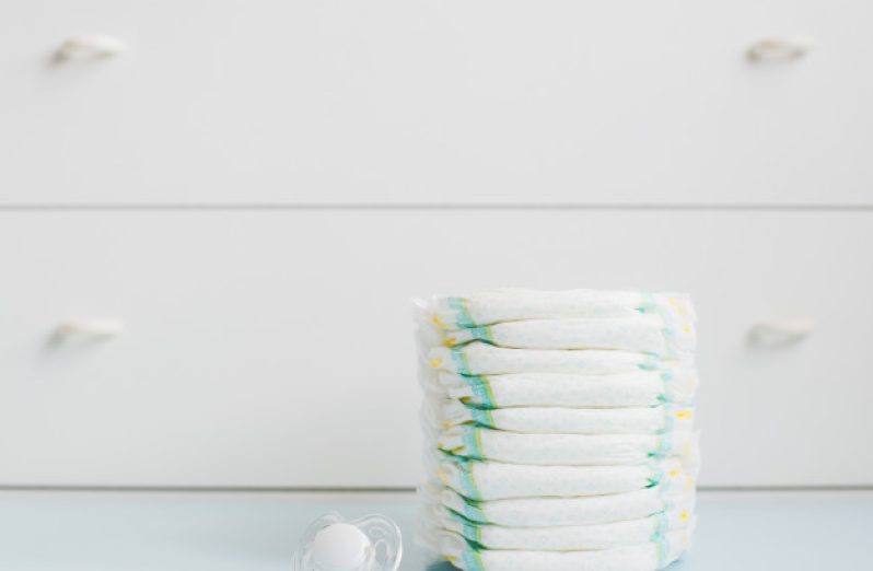 stack-diapers-against-white-wardrobe_73683-246